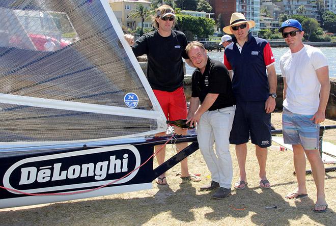 Gregg Lawrance of De'Longhi pours the traditional champagne over the new skiff in the Double Bay rigging area © Frank Quealey /Australian 18 Footers League http://www.18footers.com.au